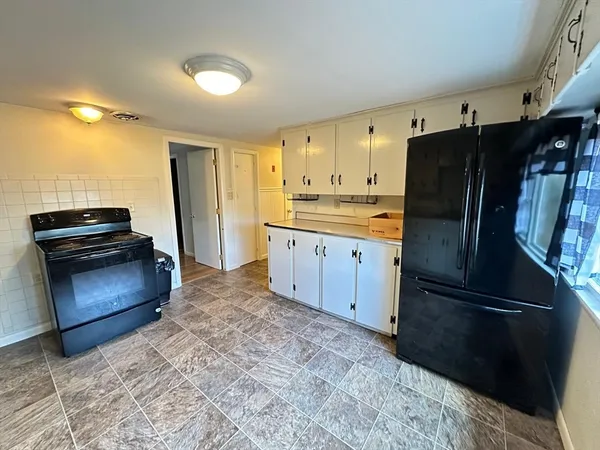 a kitchen with stainless steel appliances granite countertop a refrigerator stove and sink