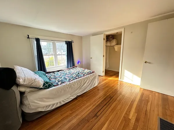 a bed sitting in a bedroom next to a window