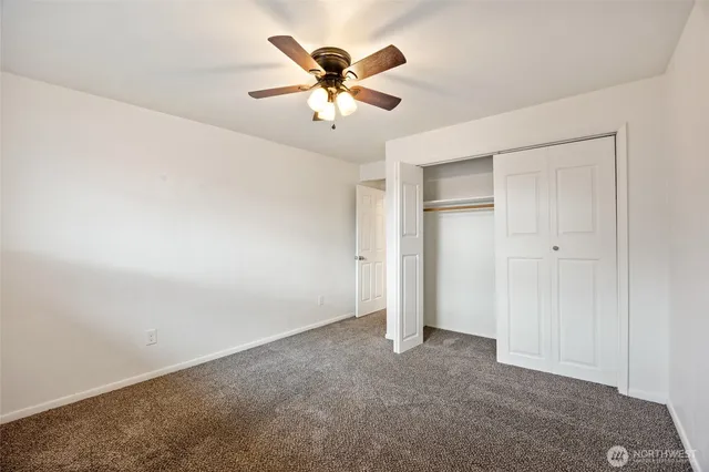 a bathroom with a sink a toilet a mirror a bathtub and shower