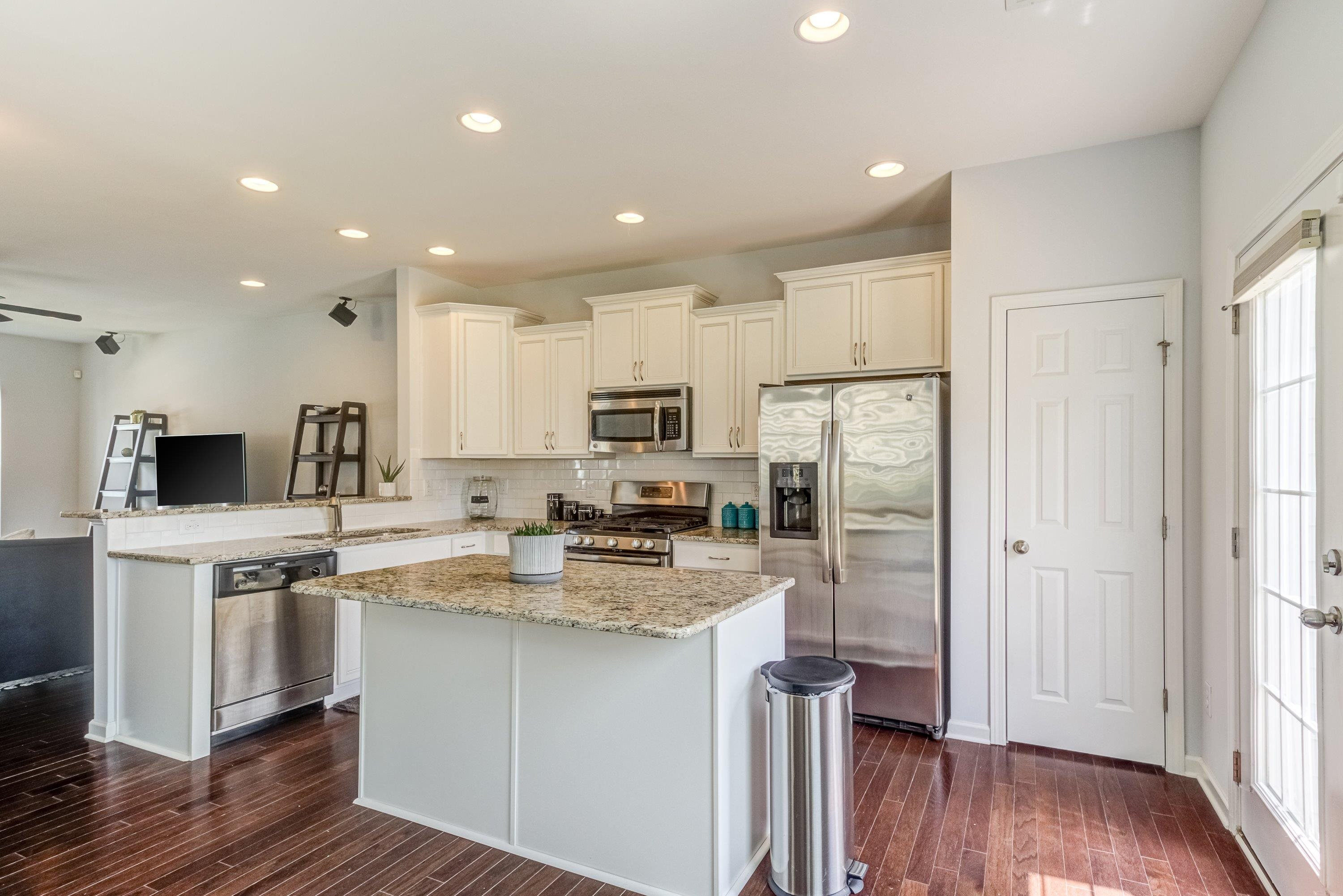 411 Provincial Street Raleigh, NC 27603 - Photo 11 of 41 a kitchen with stainless steel appliances granite countertop a refrigerator and a stove top oven