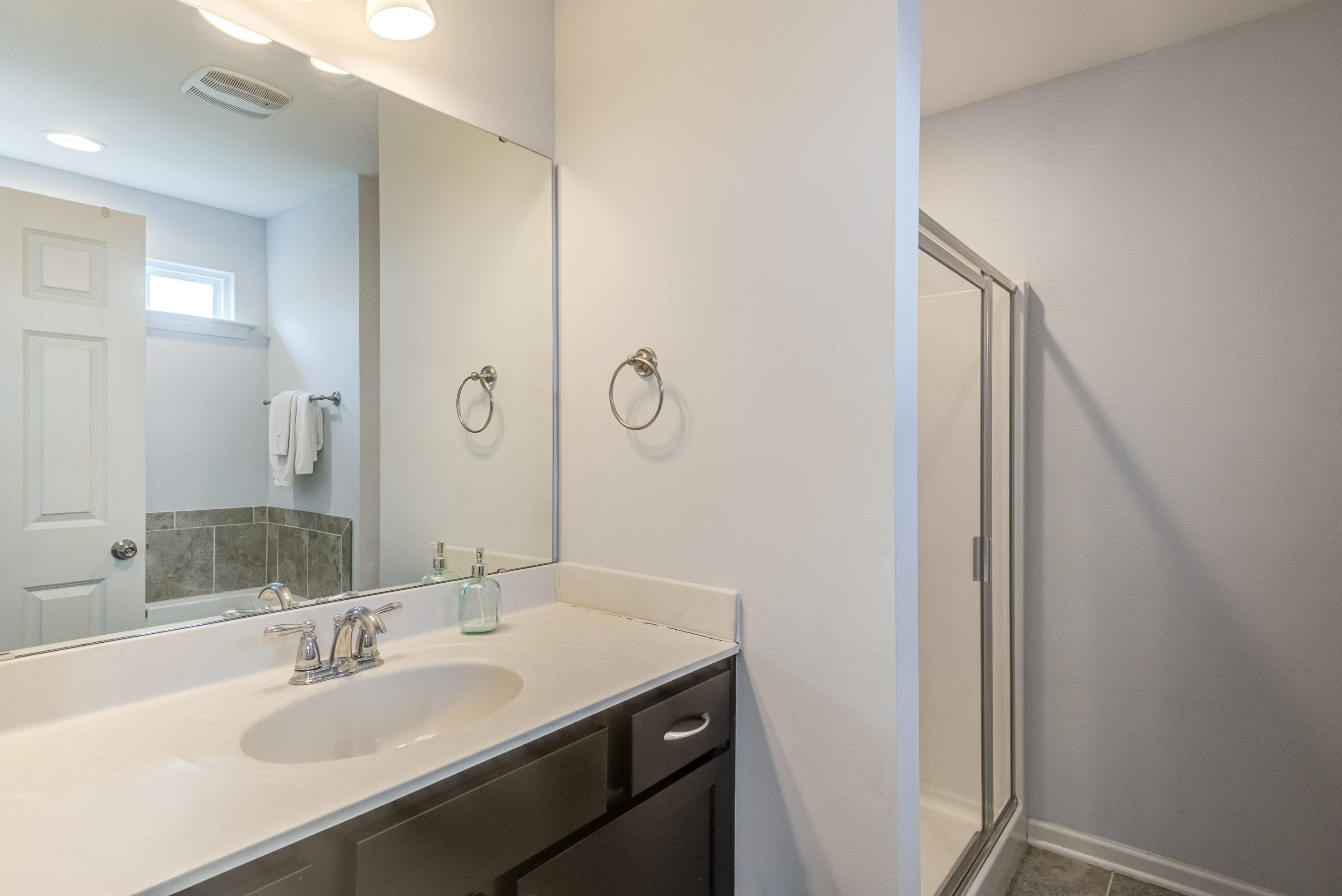 411 Provincial Street Raleigh, NC 27603 - Photo 21 of 41 a bathroom with a sink and a mirror