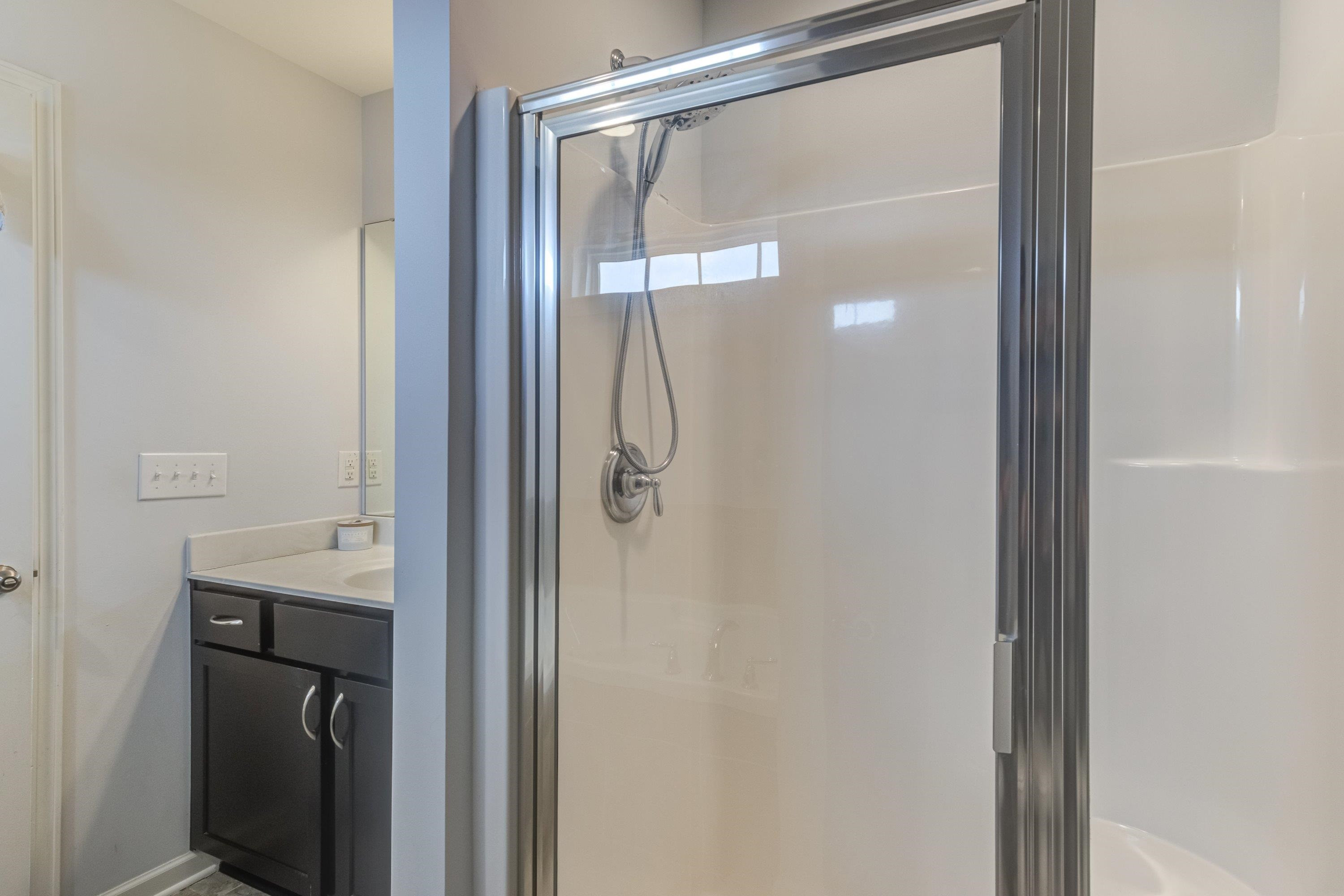 411 Provincial Street Raleigh, NC 27603 - Photo 23 of 41 a bathroom with a glass shower door