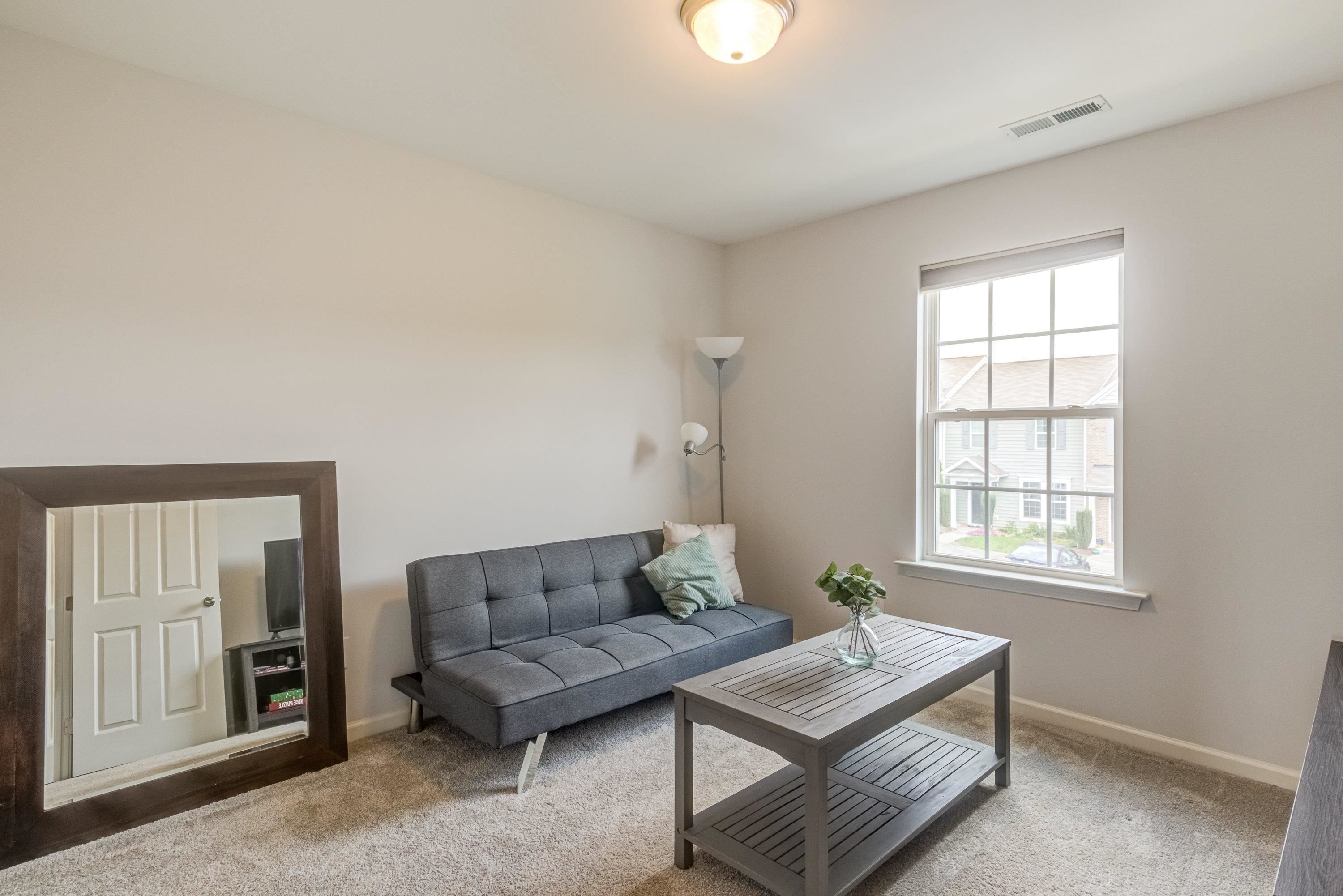 411 Provincial Street Raleigh, NC 27603 - Photo 24 of 41 a living room with furniture and a window