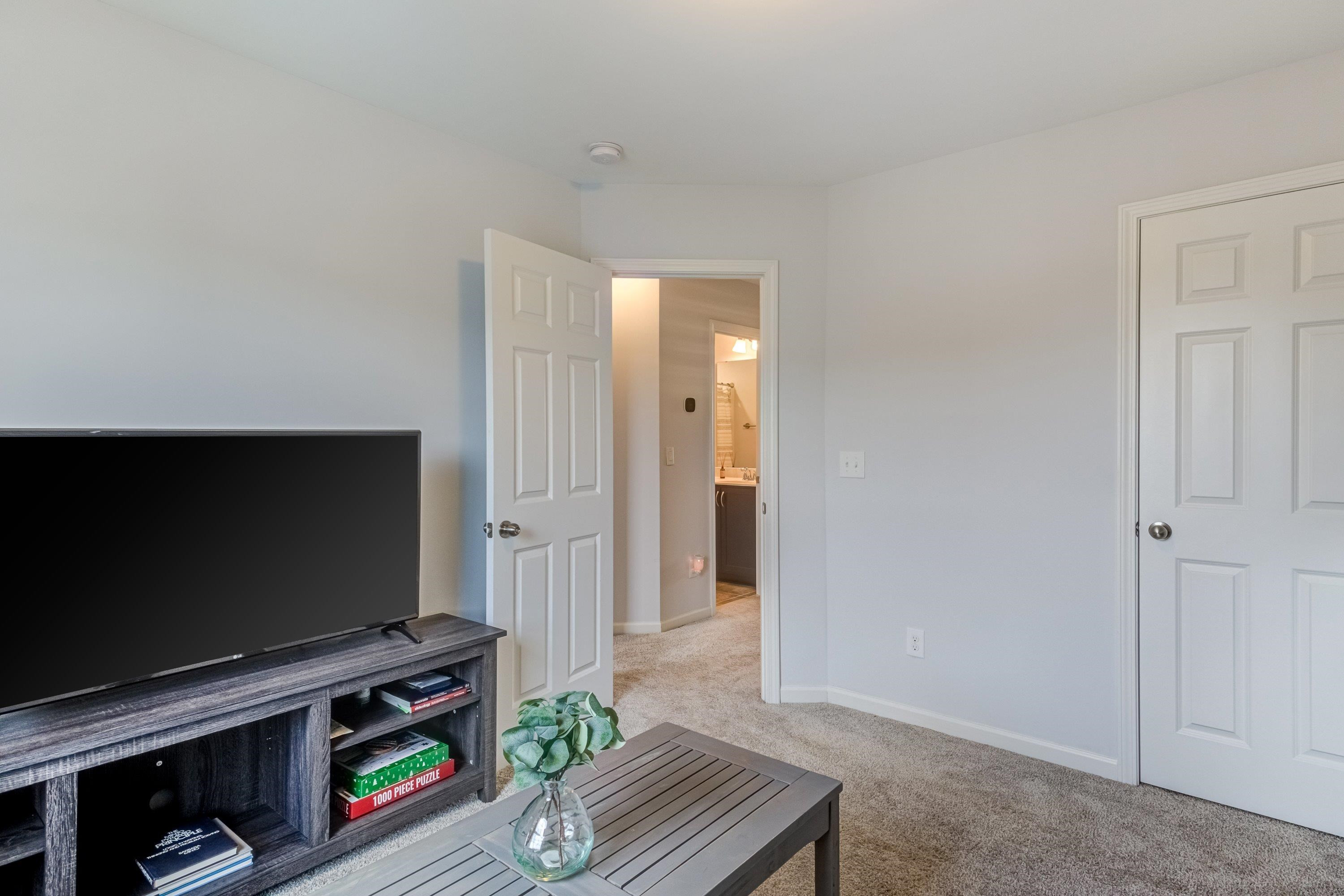 411 Provincial Street Raleigh, NC 27603 - Photo 25 of 41 a living room with furniture and a flat screen tv