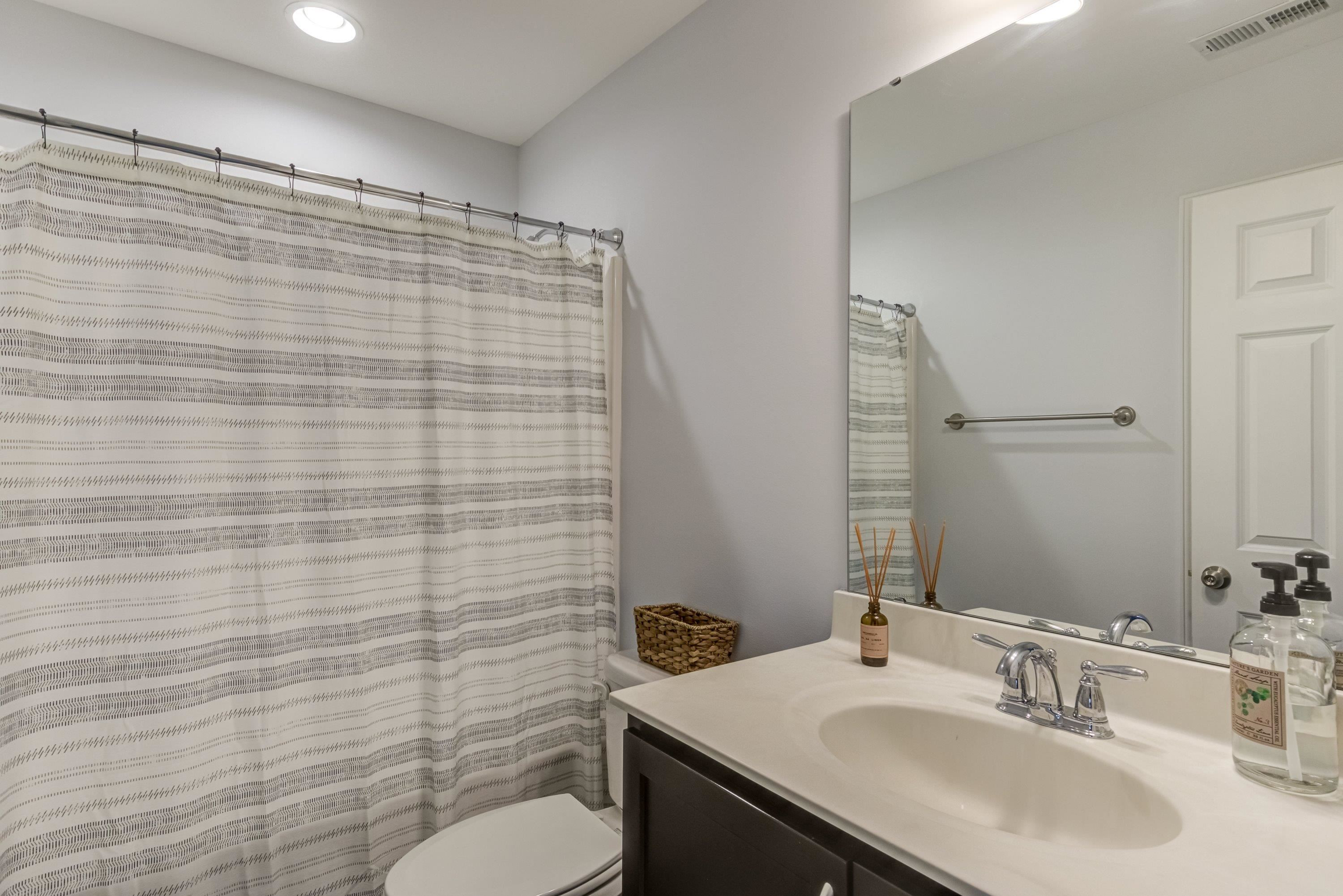 411 Provincial Street Raleigh, NC 27603 - Photo 27 of 41 a bathroom with a sink a toilet and mirror