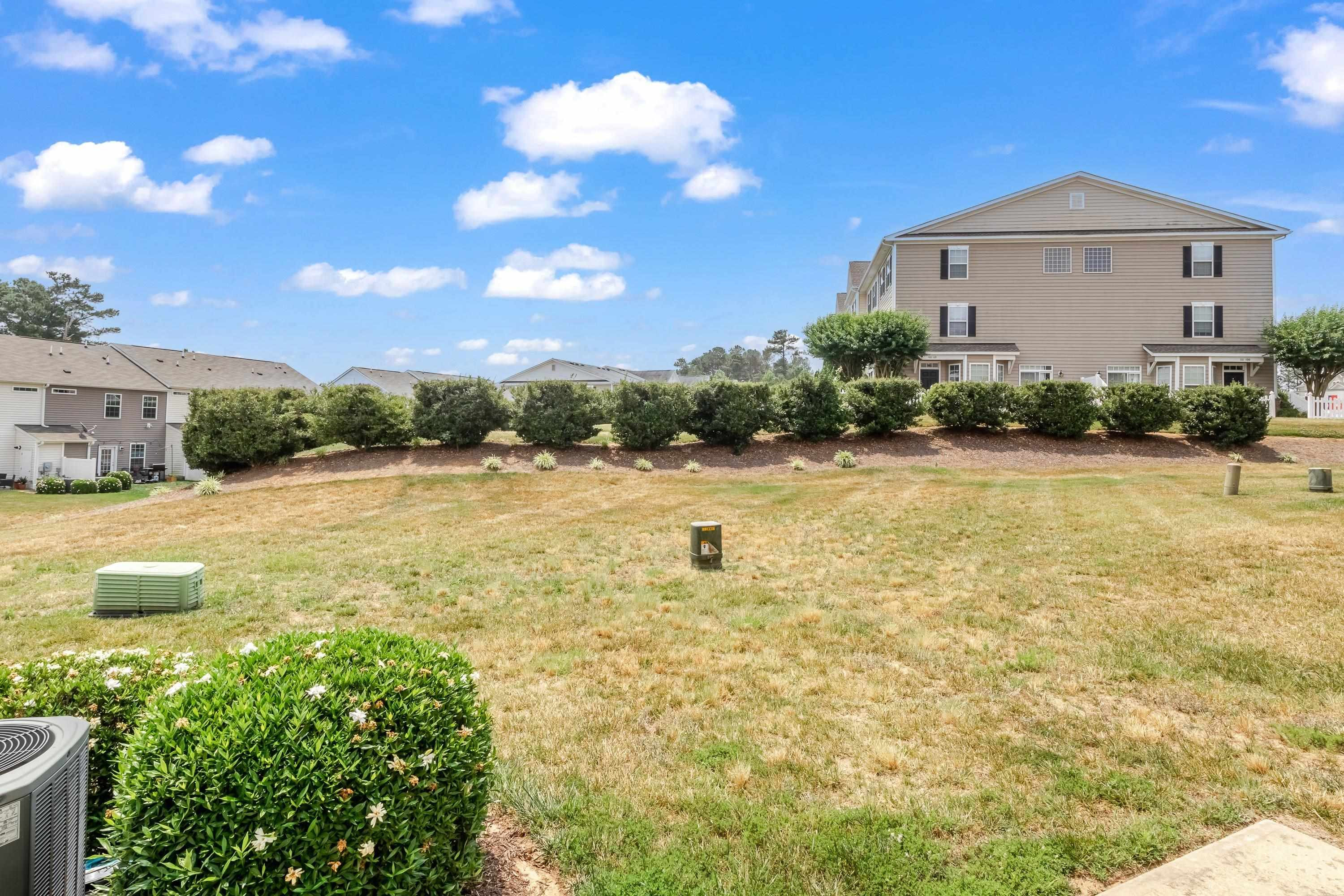 411 Provincial Street Raleigh, NC 27603 - Photo 41 of 41 a view of a house with a yard and potted plants