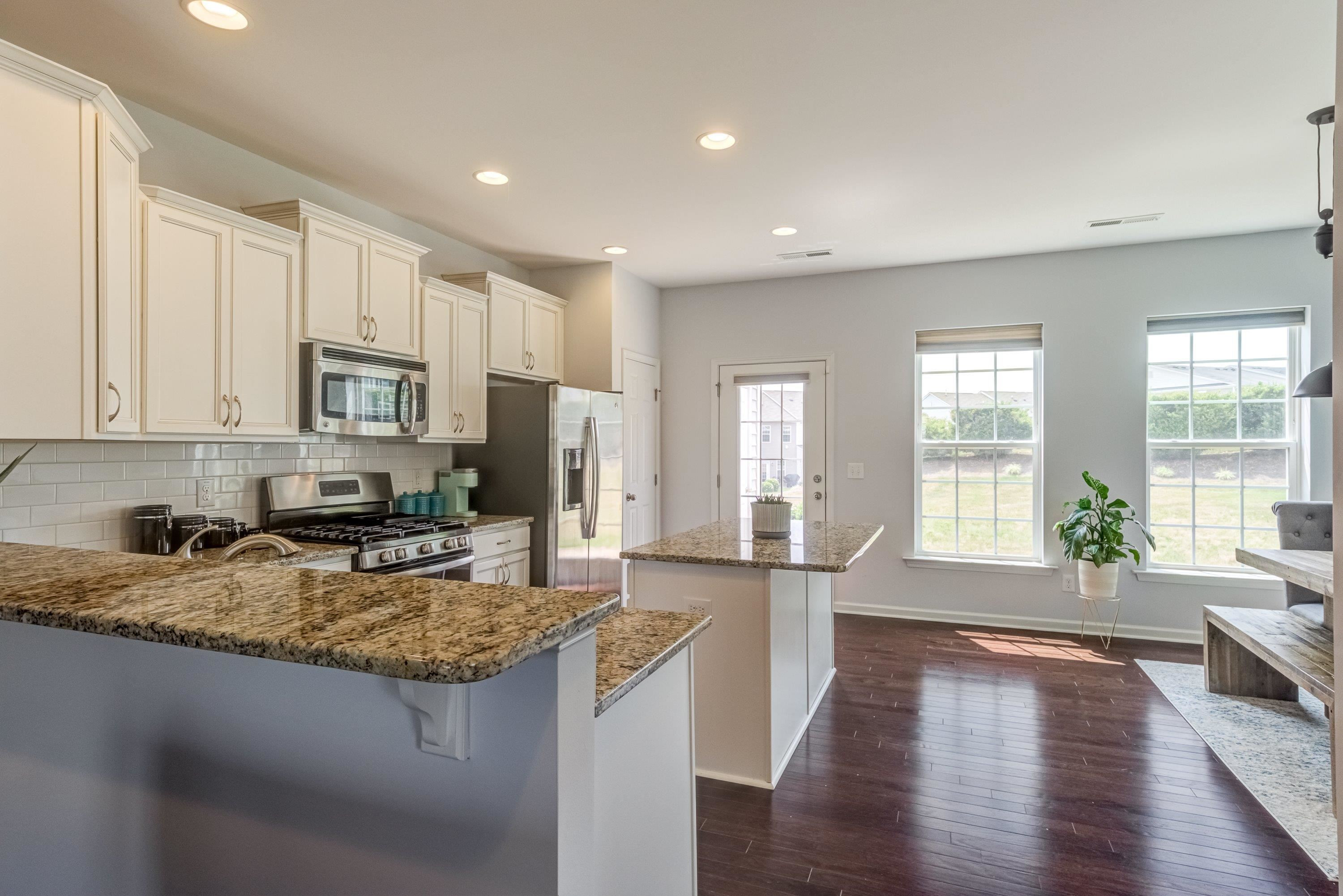 411 Provincial Street Raleigh, NC 27603 - Photo 9 of 41 a view of a kitchen with granite countertop a stove top oven a sink a counter space and cabinets