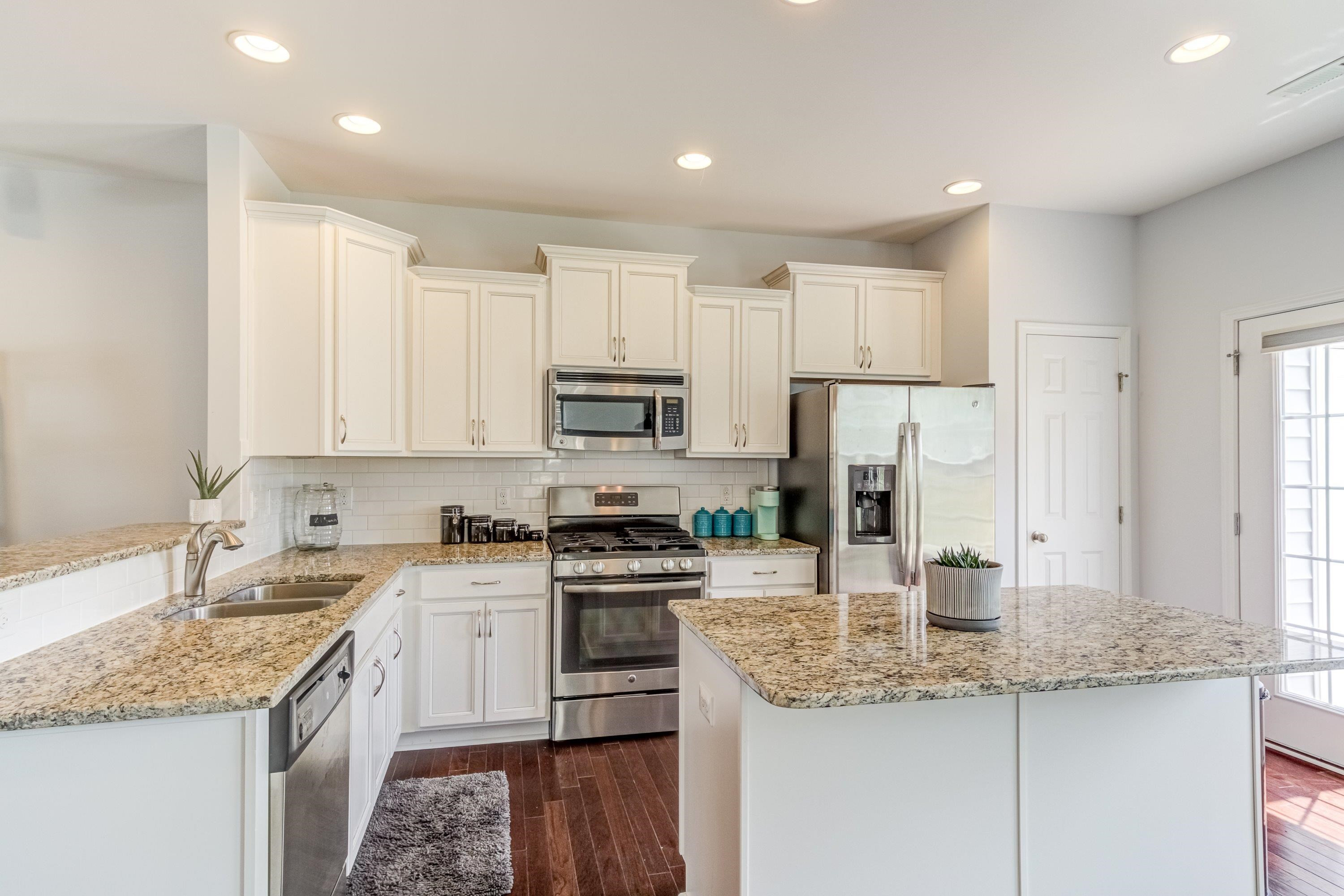 411 Provincial Street Raleigh, NC 27603 - Photo 10 of 41 a kitchen with stainless steel appliances granite countertop a sink stove and refrigerator