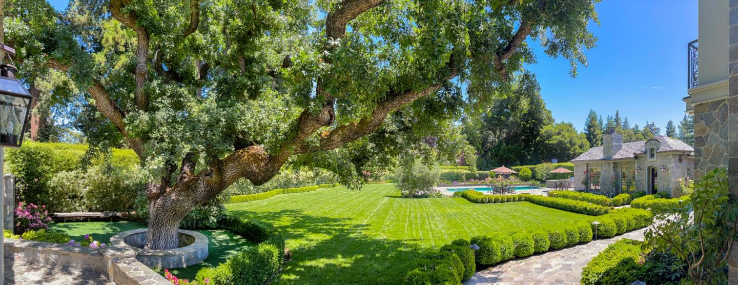 35 Ralston Road Atherton, CA 94027 - Photo 30 of 34 a view of a garden with lawn chairs under an umbrella