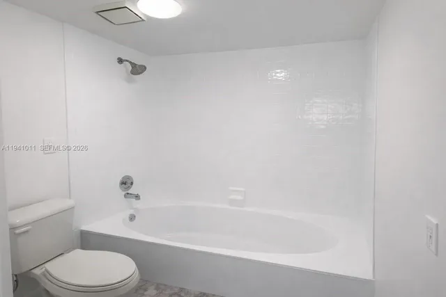 a bathroom with a bathtub and a toilet