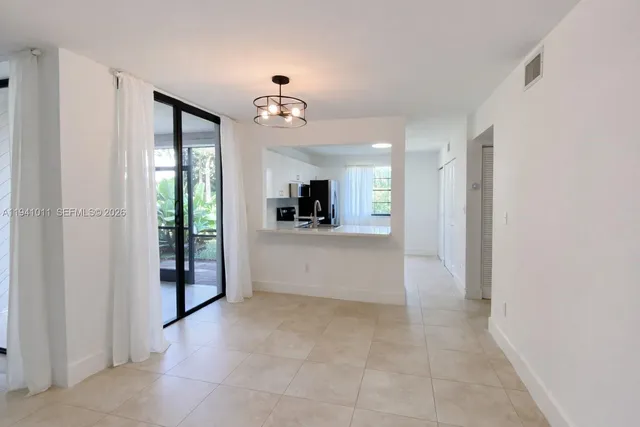 a view of a kitchen with a refrigerator and a sink