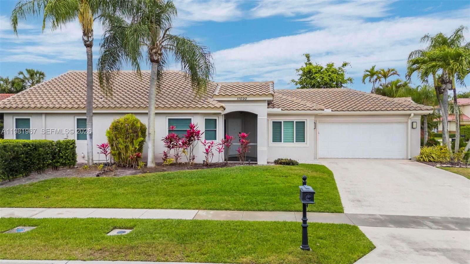 a front view of a house with a garden