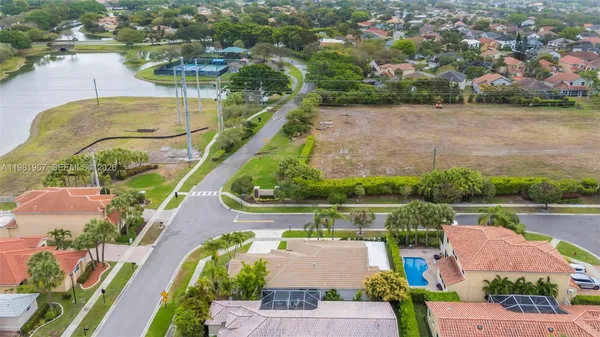 an aerial view of residential houses with outdoor space and swimming pool
