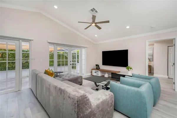a living room with furniture and a flat screen tv