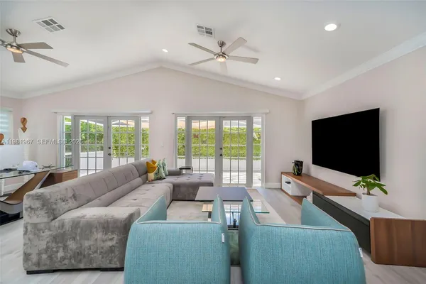 a living room with furniture and a flat screen tv