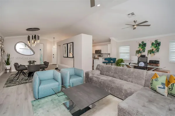 a living room with furniture and a wooden floor