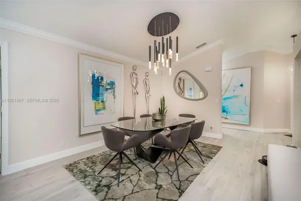 a view of a dining room with furniture and a chandelier