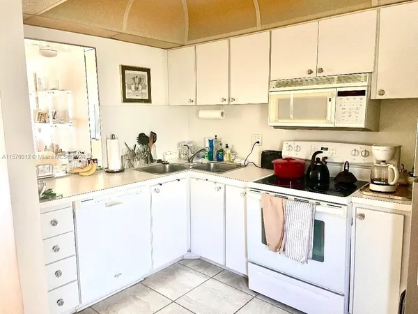 a kitchen with stainless steel appliances white cabinets and a sink