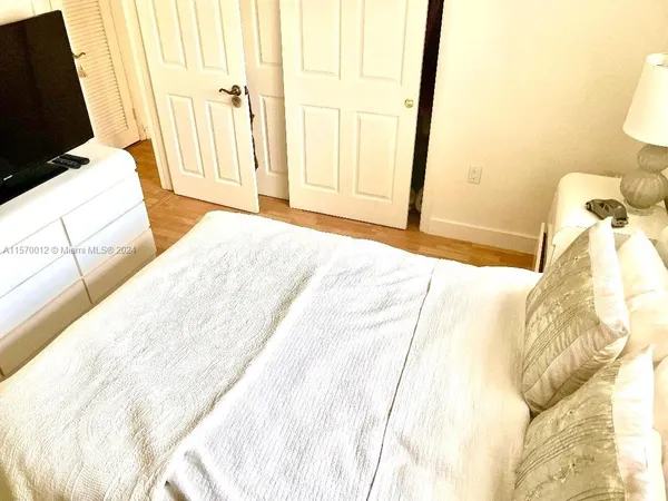 a bedroom with a bed and flat screen tv