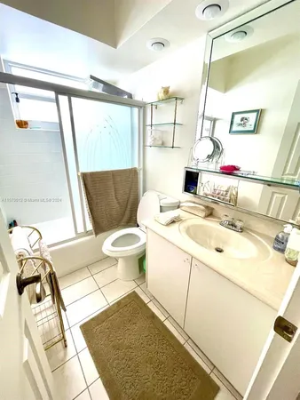 a bathroom with a sink toilet and mirror