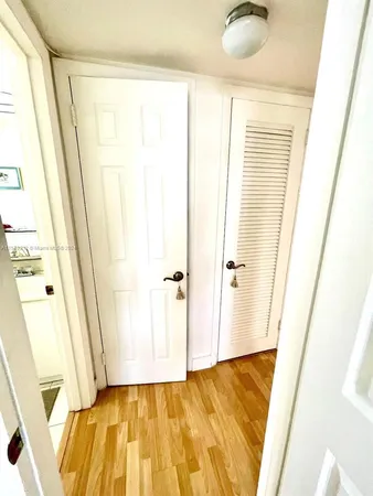 a view of a bathroom with wooden floor and a window