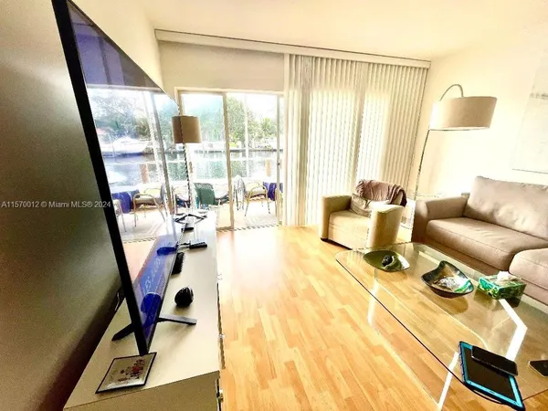 a living room with furniture and a floor to ceiling window