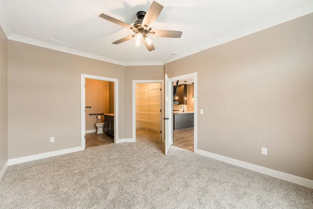 a view of a big room with closet and a ceiling fan