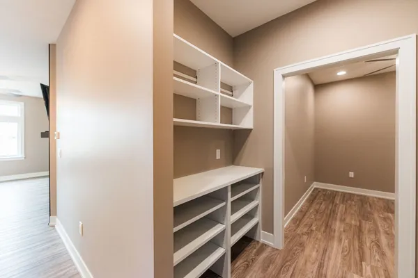 a view of walk in closet with empty racks