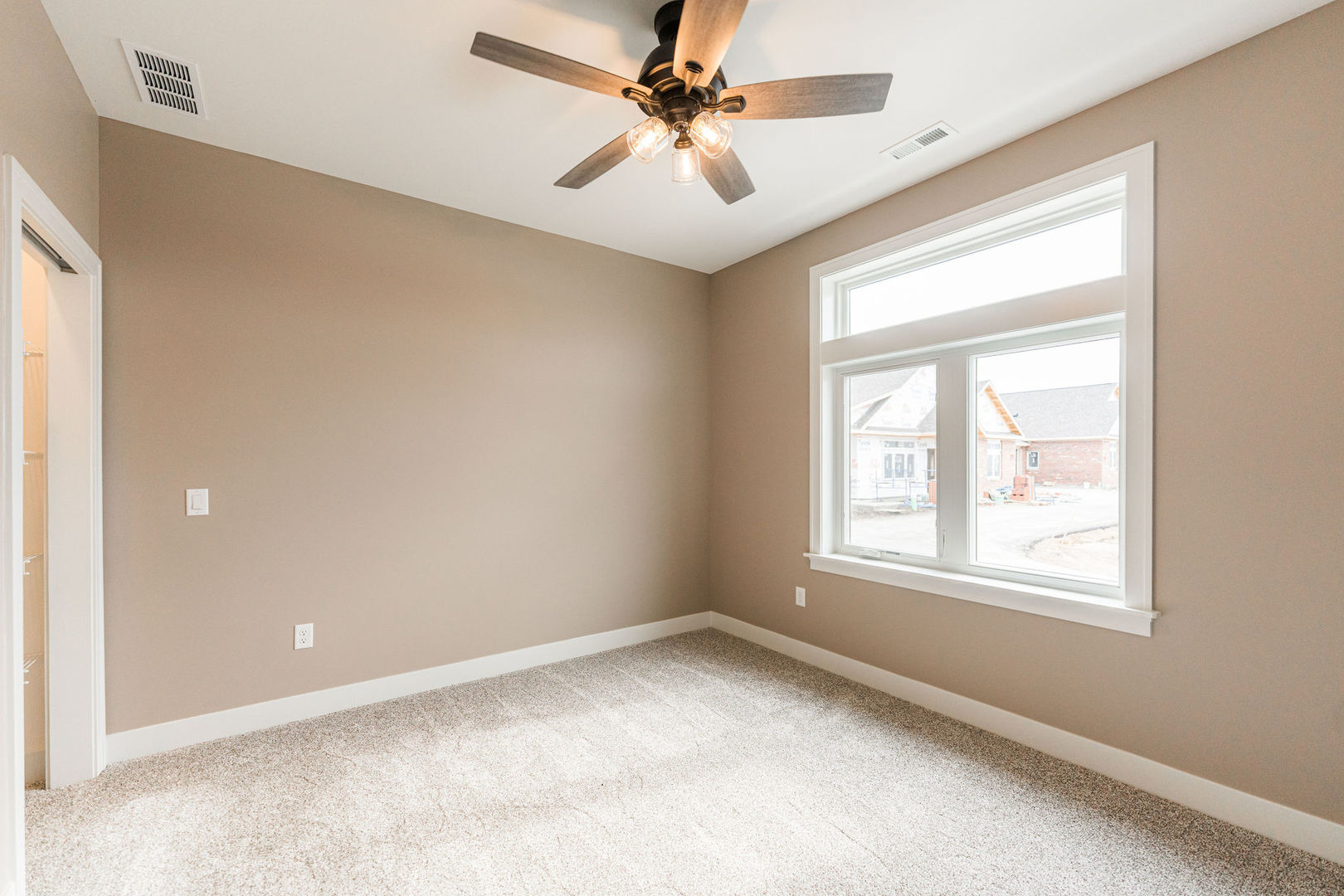 563 Stearn Drive, Unit 563 Genoa, IL 60135 - Photo 9 of 50 an empty room with a window and a fan