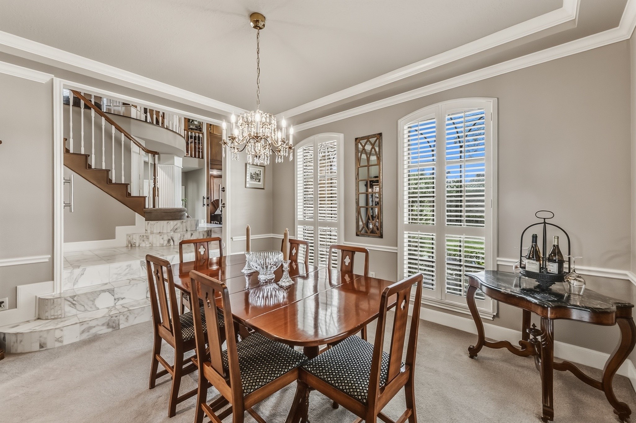 6047 Spring Creek Lane Spring, TX 77379 - Photo 13 of 50 Just beyond the other side of the grand foyer, the formal dining room offers a setting that feels tailored for holiday gatherings and candlelit dinners alike. Arched openings, rich flooring, and natural light create an atmosphere that is polished yet comfortably lived in.