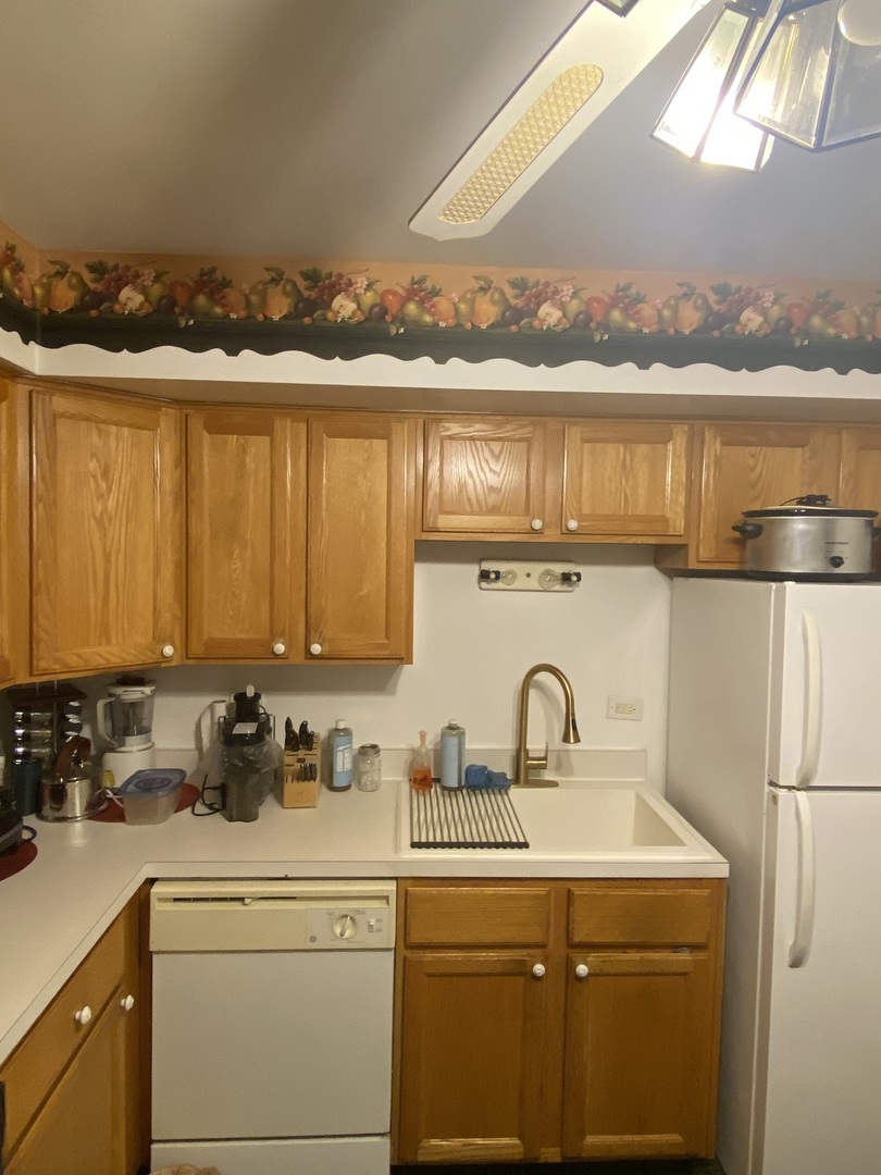 2222 South Goebbert Road, Unit 459 Arlington Heights, IL 60005 - Photo 8 of 18 a kitchen with a sink cabinets and appliances