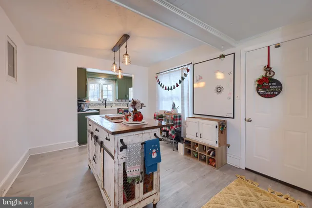 a view of living room kitchen and entryway