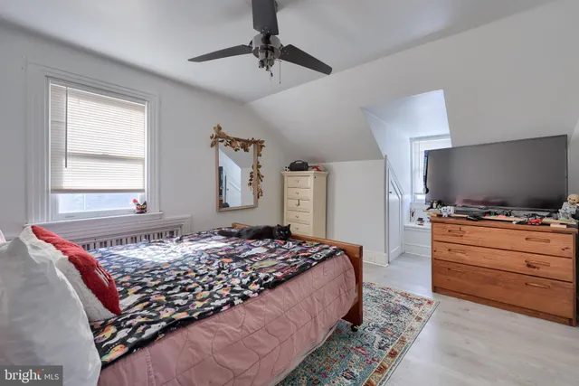 a bedroom with bed and flat screen tv