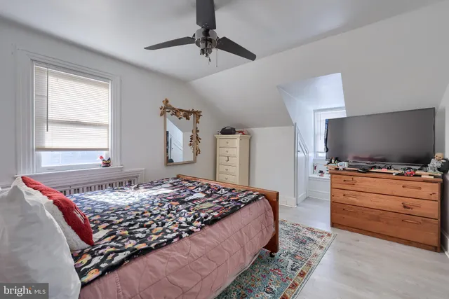 a bedroom with a bed and flat screen tv