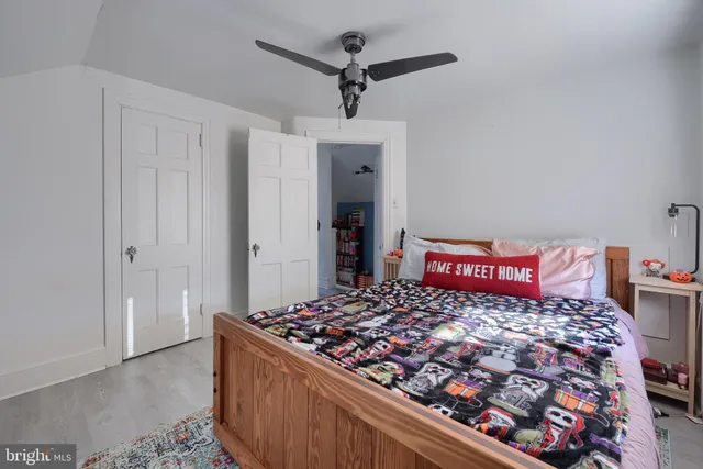 a bedroom with a large bed and a chandelier