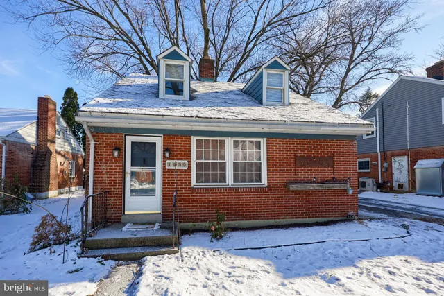 a view of house with a large tree