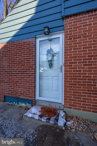 a view of a door and brick walls