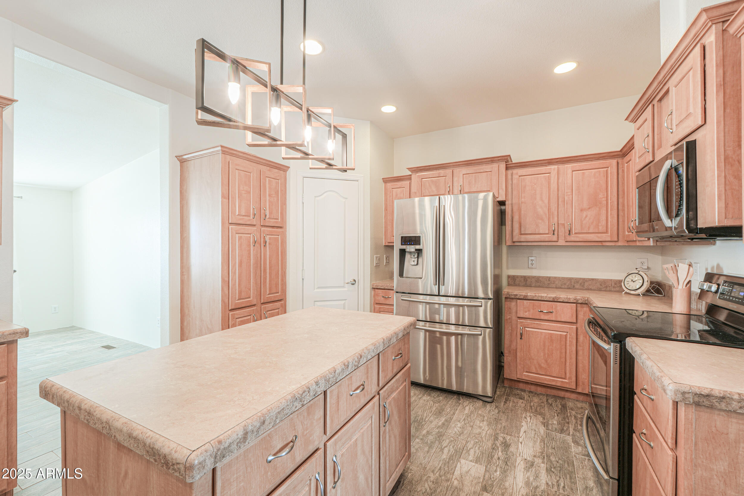 176 North Acacia Road Apache Junction, AZ 85119 - Photo 11 of 65 a kitchen with stainless steel appliances a refrigerator sink and cabinets