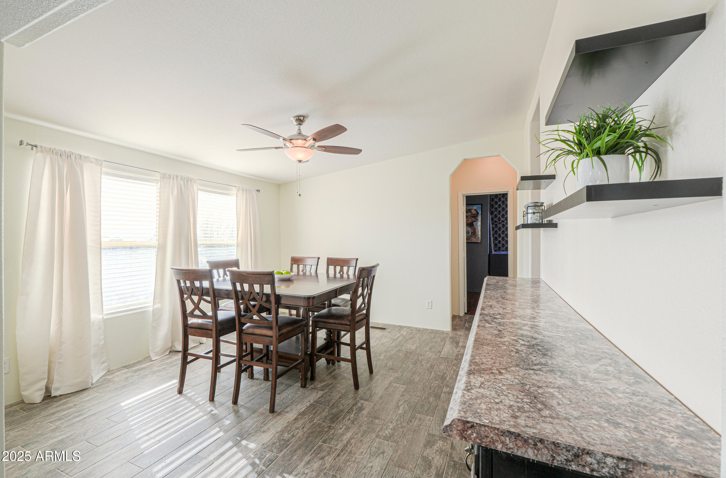 176 North Acacia Road Apache Junction, AZ 85119 - Photo 20 of 65 a view of a dining room with furniture and a potted plant