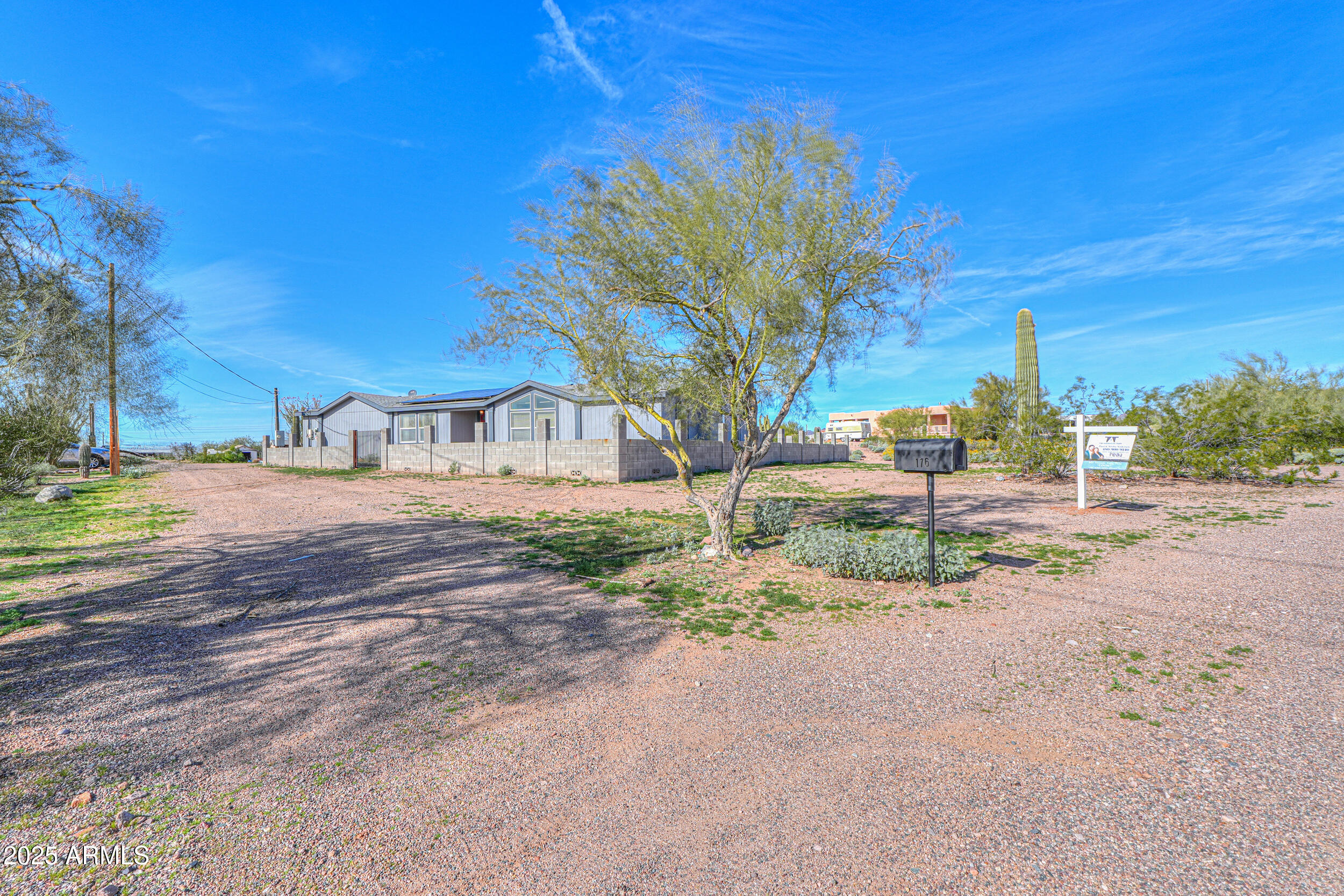 176 North Acacia Road Apache Junction, AZ 85119 - Photo 2 of 65 a street view with large trees