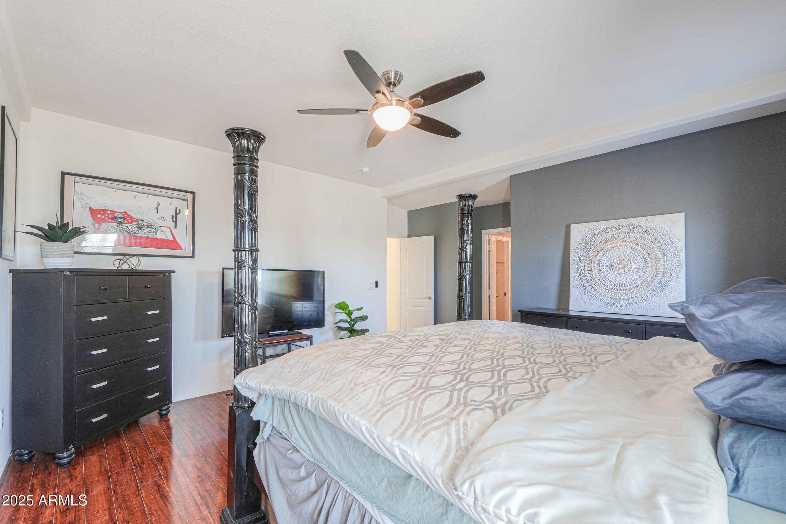 176 North Acacia Road Apache Junction, AZ 85119 - Photo 24 of 65 a bedroom with a bed and a chandelier