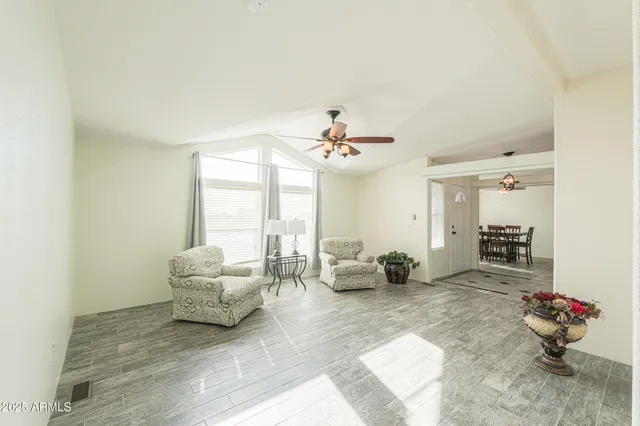a workspace with wooden floor and a window