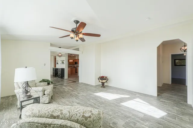 a living room with furniture and a wooden floor