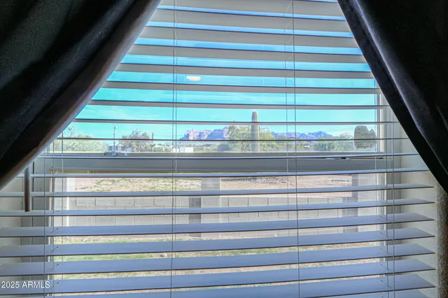 a living room with furniture and a mirror