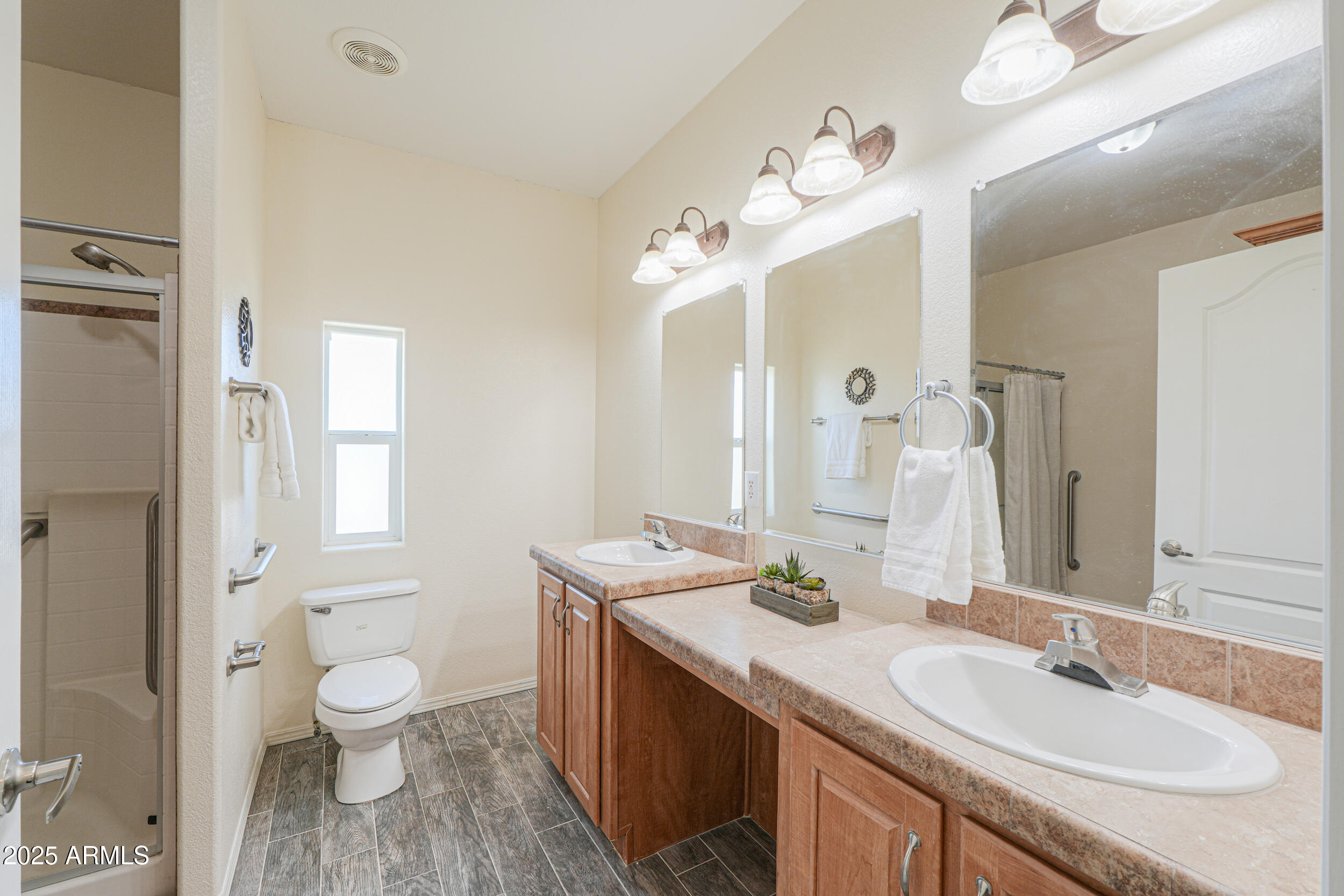 176 North Acacia Road Apache Junction, AZ 85119 - Photo 40 of 65 a bathroom with a granite countertop double vanity sink a mirror and a toilet