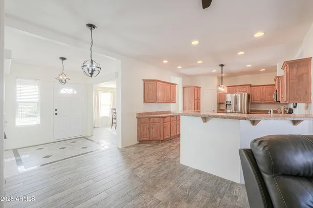 a large kitchen with granite countertop a large counter top stainless steel appliances and a counter top space