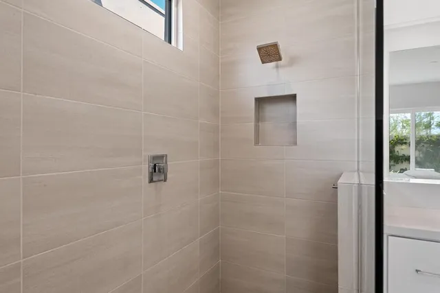 a bedroom with a bed and a dresser in it