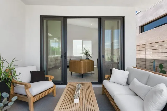 a backyard of a house with table and chairs