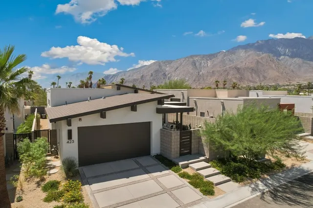 a view of a porch with a table and chairs