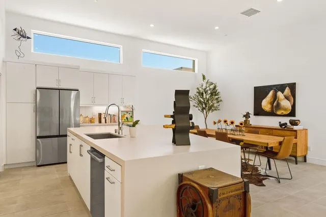 a kitchen with refrigerator and cabinets